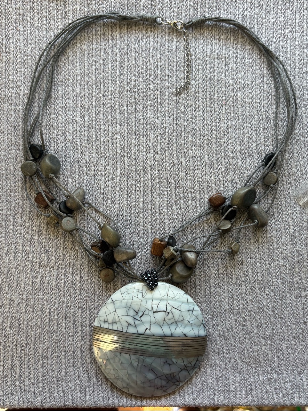 Bohemian theme multistrand wooden beaded necklace w round cracked shell pendant